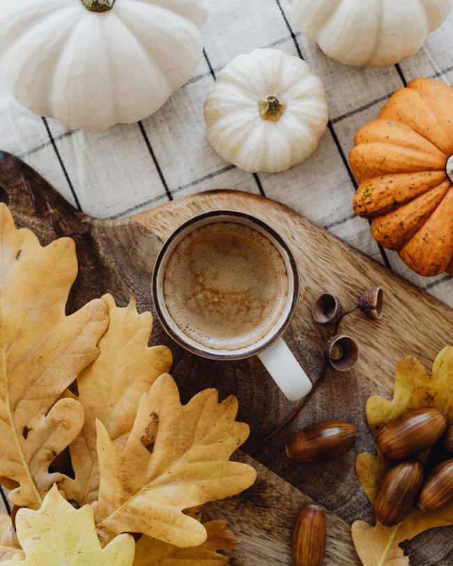 Cappuccino met herfstbladeren en pompoenen